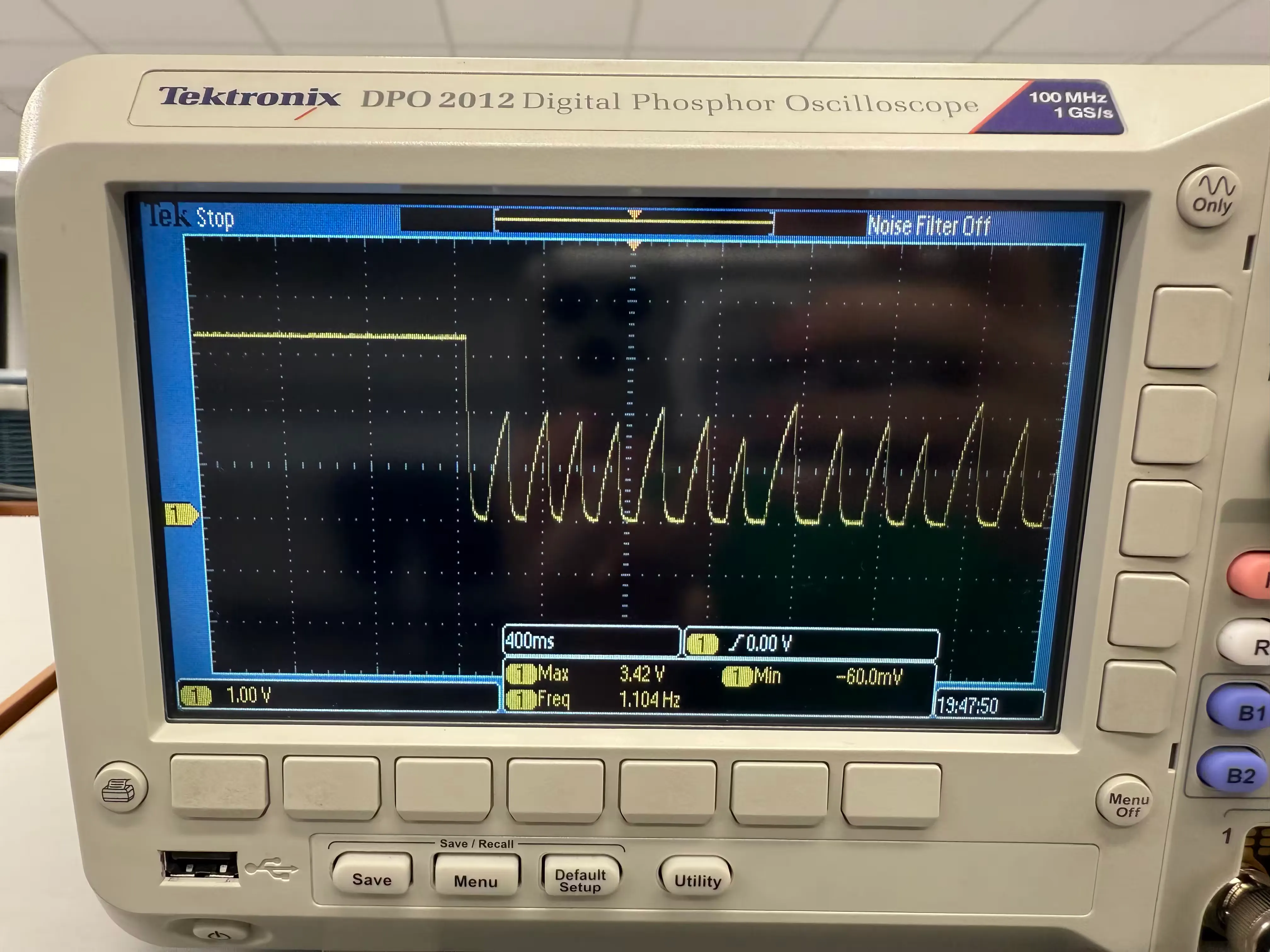 Picture of an oscilloscope with a sawtooth-like waveform.